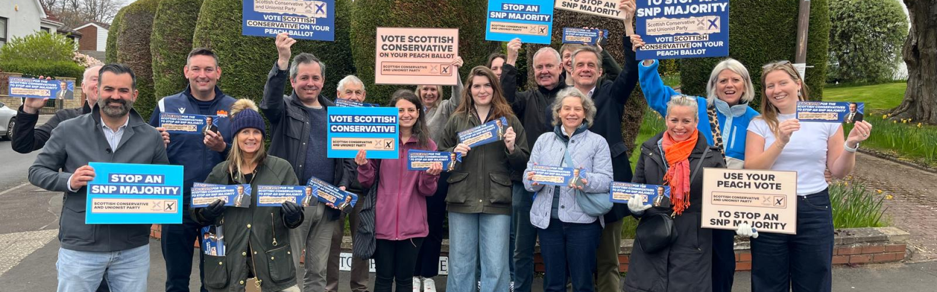 Group of campaigners with Scottish conservative signs