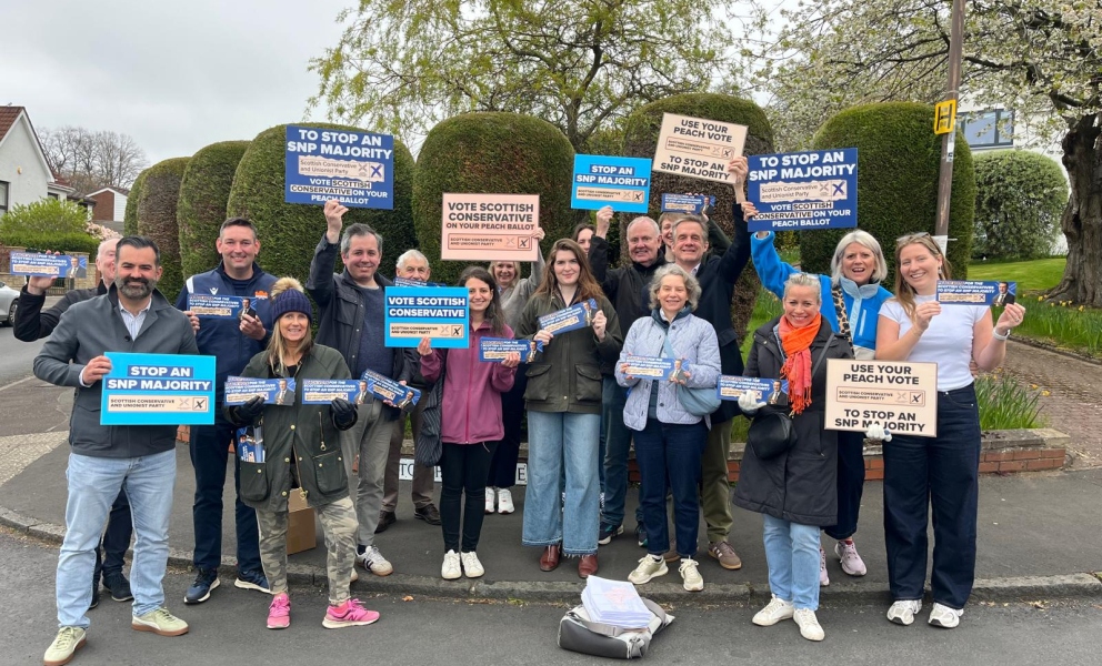 Group of campaigners with Scottish conservative signs