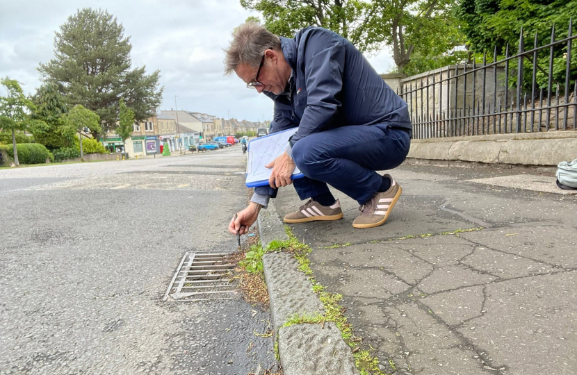 Man inspecting gully