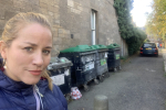 Cllr Marie Clair Munro is standing next to a bin hub.