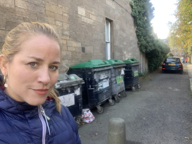 Cllr Marie Clair Munro is standing next to a bin hub.