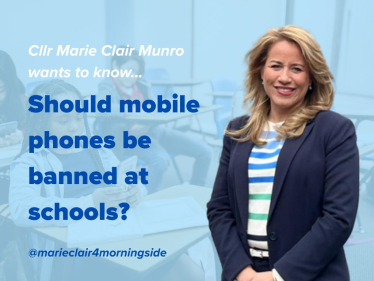Children are at school with mobile phones in their hand inside the classroom.
